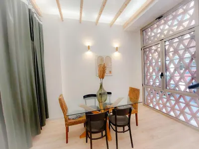 a dining room with a glass table and chairs at Ruzafa in love in Valencia
