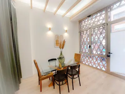 a dining room with a glass table and chairs at Ruzafa in love in Valencia