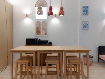 a kitchen with a wooden table and stools at Ruzafa in love in Valencia