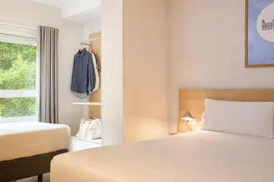 a hotel room with a bed and a window at Rooms Ciencias in Valencia