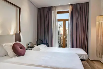 a hotel room with two beds and a window at Vincci Palace in Valencia