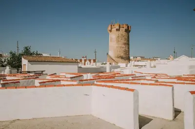 a view of the roofs of a city with a lighthouse at BONITA CASA CUEVA CON JACUZZI in Paterna