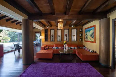 a living room with orange couches and a purple rug at Villa Huerta 2, Paterna, jacuzzi, sauna in Paterna