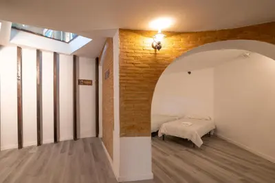 a bedroom with a bed and a brick wall at Villa Huerta 2, Paterna, jacuzzi, sauna in Paterna