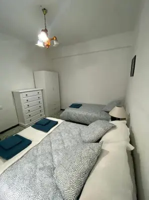 a bedroom with two beds and a dresser at Casa en Puerto de Sagunto. Playa in Canet de Berenguer