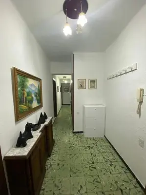a hallway with a bathroom with sinks and a painting on the wall at Casa en Puerto de Sagunto. Playa in Canet de Berenguer