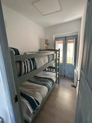 a couple of bunk beds in a room at Acogedora y moderna casa en pueblo in Serra