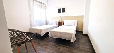 a small room with two beds and a chair at Dionis Silence in Valencia