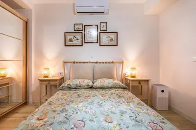 a bedroom with a bed with two night stands at Cala Brull - Acogedor apartamento a 10 minutos de la playa in Valencia
