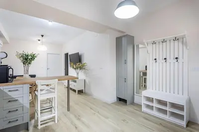 a kitchen with white cabinets and a wooden counter top at Cala Brull - Acogedor apartamento a 10 minutos de la playa in Valencia