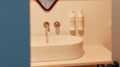 a bathroom sink with two faucets on a counter at Casa Clarita in Valencia