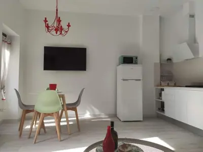 a kitchen with a table and chairs in a room at Barcabanyal in Valencia