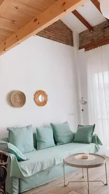 a living room with a green couch and a table at Barcabanyal in Valencia