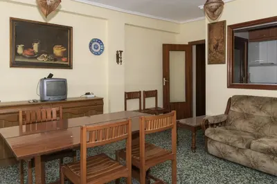 a living room with a table and a couch at Levante, 6-J in Cullera