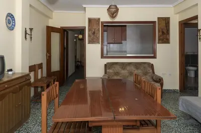 a living room with a wooden table and a couch at Levante, 6-J in Cullera