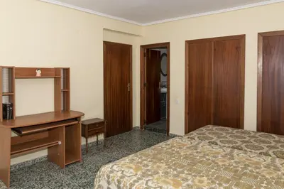 a bedroom with a desk and a bed with a desk at Levante, 6-J in Cullera