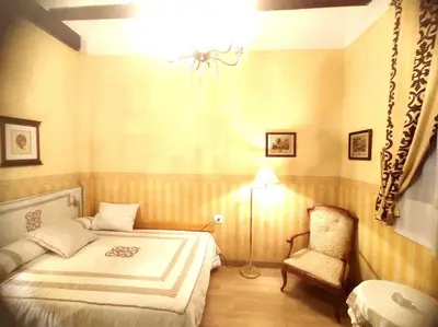 a bedroom with a bed and a chair at Encantadora casa de pueblo in Sagunto