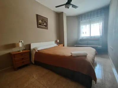 a bedroom with a bed and a ceiling fan at Playa Paradís - Primera linea de playa - AP-7 3min - Self check-in 24h in Moncófar