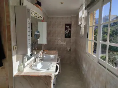 a bathroom with two sinks and a mirror at Terrace & Sea Views in Cullera in Faro de Cullera