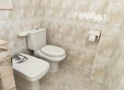 a bathroom with a white toilet and a sink at Terrace & Sea Views in Cullera in Faro de Cullera