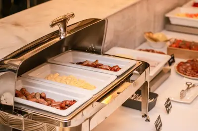 a buffet with a tray of food and a sink at The Valentia Corretgería in Valencia
