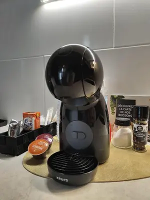 a black coffee maker sitting on a counter at Hlius Brand New Apartments in Valencia