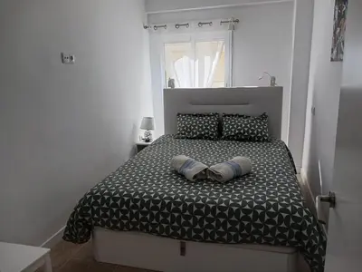 a bedroom with a bed with two pillows on it at A 50 m de la plage in Cullera