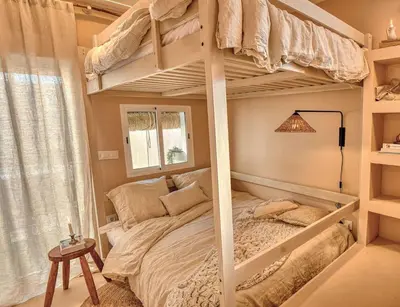 a bedroom with two bunk beds and a lamp at Suite con Jacuzzi en la montaña. in Llombay