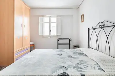 a bedroom with a large bed and a dresser at private room in shared apartment Valencia WorkStay in Valencia
