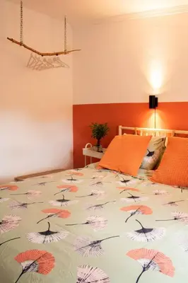 a bedroom with a bed with a comforter with umbrellas at Casa Mas Montanas vakantiehuis met zwembad Max 10-12 pers Vlakbij Valencia in Godelleta