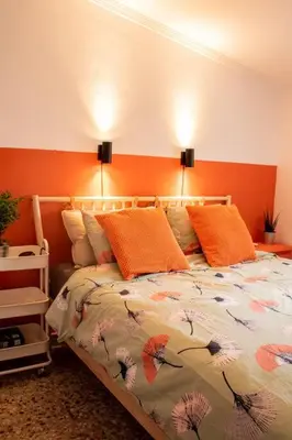 a bedroom with a bed with an orange headboard at Casa Mas Montanas vakantiehuis met zwembad Max 10-12 pers Vlakbij Valencia in Godelleta