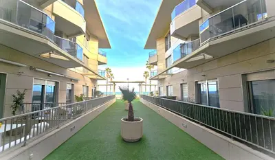 a hallway of an apartment building with a potted plant at BEACH VALENCIA LUXURY B40-7 Apartament on Beach in Valencia