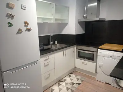 a kitchen with a white refrigerator and a sink at Apartamento playa in Playa Pobla de Farnals