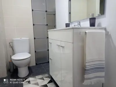 a bathroom with a white toilet and a sink at Apartamento playa in Playa Pobla de Farnals