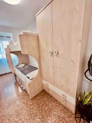 a wooden cabinet with a bunk bed in a room at Citadella Apartment in Puerto de Sagunto