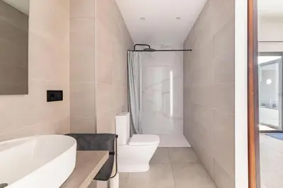a bathroom with a toilet and a tub and a sink at PR27 in Valencia