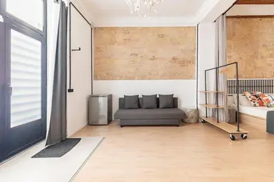 a living room with a couch and a chandelier at PR27 in Valencia