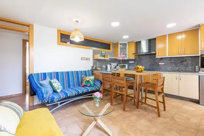 a living room with a blue couch and a table at Aparthotel Mediterráneo by NeoHotels-Centro 8 min by Metro in Valencia