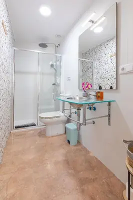 a bathroom with a shower and a sink and a toilet at Aparthotel Mediterráneo by NeoHotels-Centro 8 min by Metro in Valencia