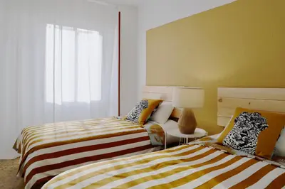a bedroom with two beds and a window at Almar Collection Cullera AR in Cullera
