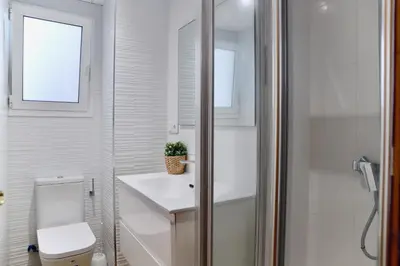 a bathroom with a toilet and a sink and a shower at Almar Collection Cullera AR in Cullera