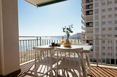 a table and chairs on a balcony with a view of the ocean at Almar Collection Cullera AR in Cullera