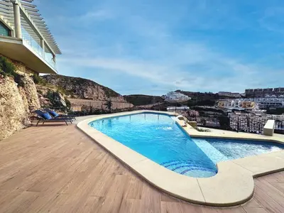 a swimming pool on top of a building at Colina del Sol Penthouse Horizonte in Cullera