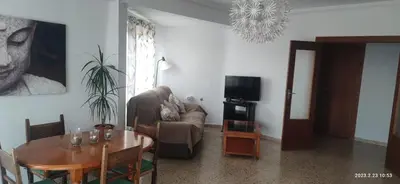a living room with a couch and a table at Apartamento 1ª línea de Playa in Puebla de Farnals