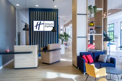 a lobby with a blue couch and a table at Holiday Inn Express Ciudad de las Ciencias by IHG in Valencia