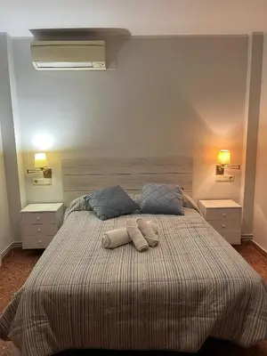 a bedroom with a large bed with two pillows at Casa Las Emilias en La Cañada in Partida de La Cañada