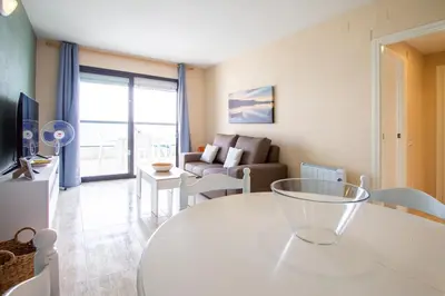 a living room with a table and a couch at ESPACIO 18 - Primera Línea de Playa in Cullera