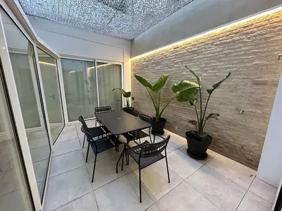 a table and chairs on a balcony with plants at Precioso apartamento con patio. PYP in Valencia