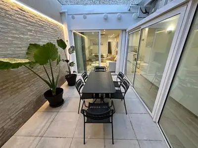 a black table and chairs on a balcony with a table at Precioso apartamento con patio. PYP in Valencia