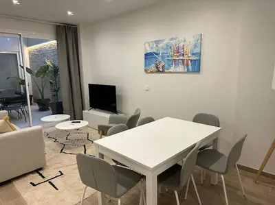 a living room with a white table and chairs at Precioso apartamento con patio. PYP in Valencia